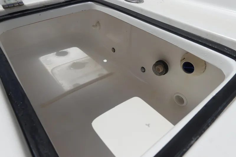 Slide: The Image of 2022 Sea Hunt Gamefish 27 Coffin Box interior, showcasing spacious storage and drainage features. - 13