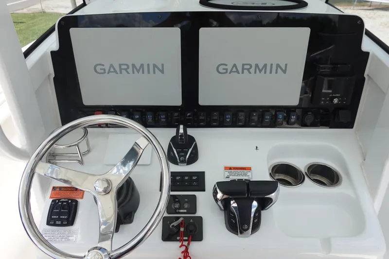 Slide: The Image of 2022 Sea Hunt Gamefish 27 dashboard with Garmin displays and controls. - 19