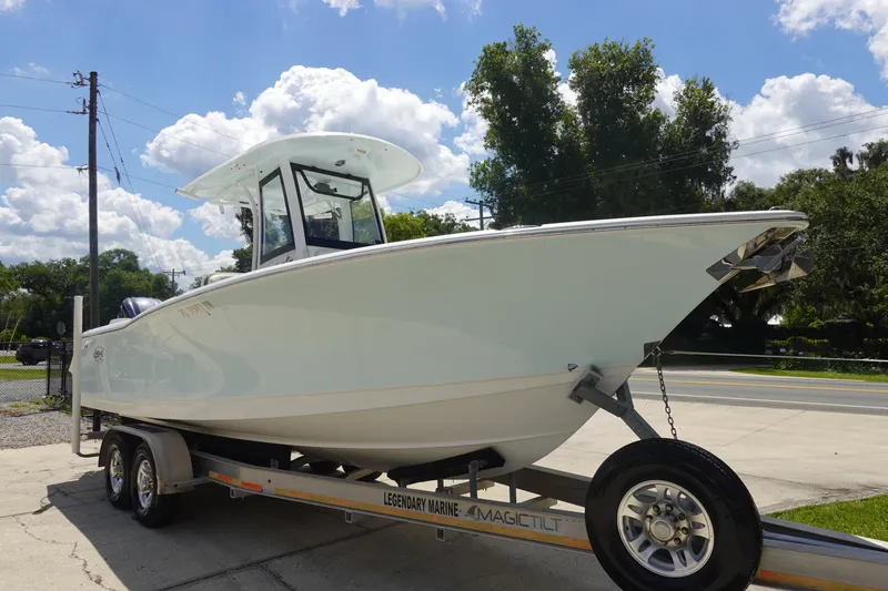 Slide: The Image of 2022 Sea Hunt Gamefish 27 Coffin Box boat on trailer under blue sky. - 2