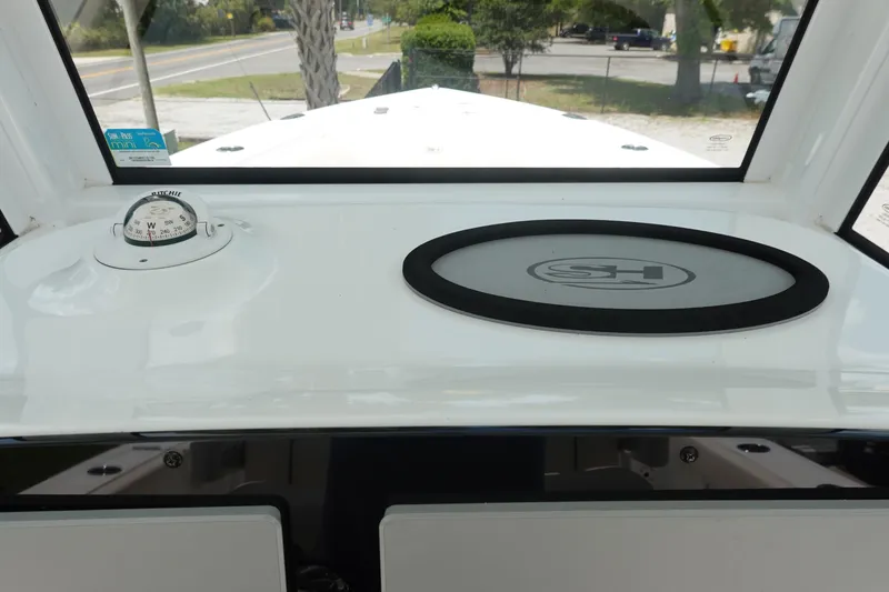 Slide: The Image of 2022 Sea Hunt Gamefish 27 Coffin Box dashboard with compass and logo. - 21