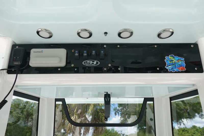 Slide: The Image of 2022 Sea Hunt Gamefish 27 Coffin Box dashboard with Garmin device and colorful sticker. - 22