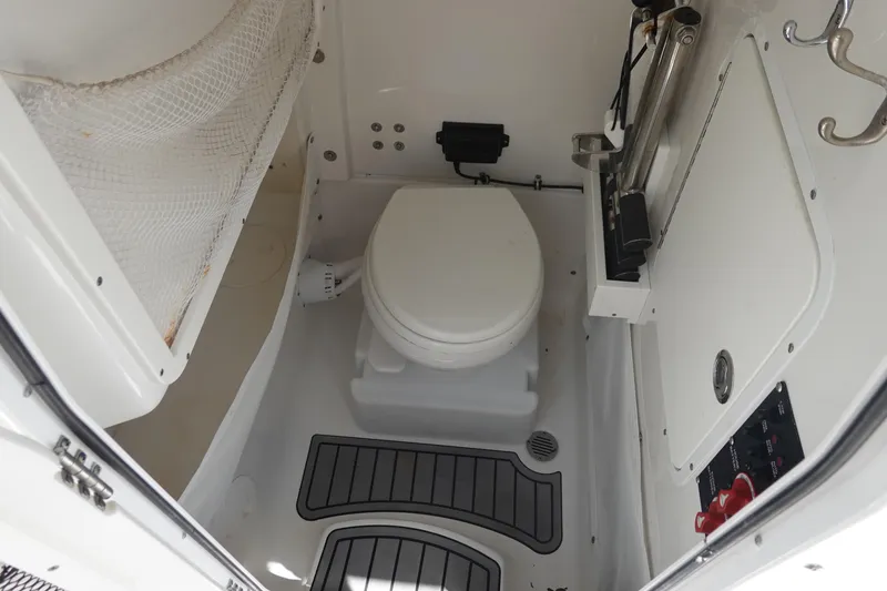 Slide: The Image of 2022 Sea Hunt Gamefish 27 Coffin Box boat interior with compact marine toilet. - 34