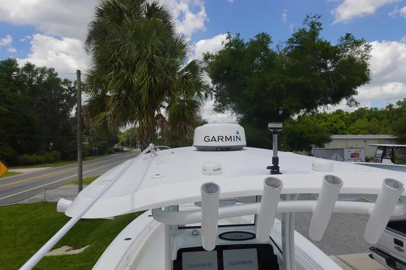 Slide: The Image of 2022 Sea Hunt Gamefish 27 Coffin Box with Garmin equipment, parked near palm trees. - 35