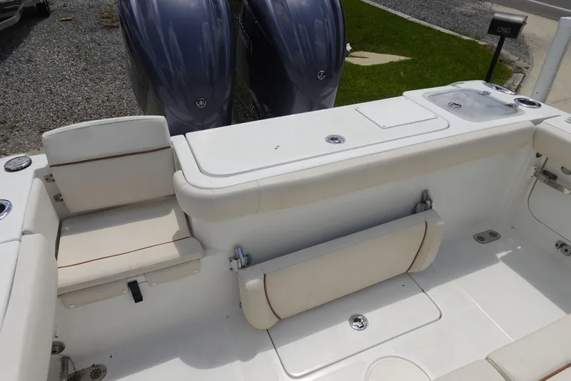 Slide: The Image of 2022 Sea Hunt Gamefish 27 Coffin Box boat interior with seating and dual engines. - 5