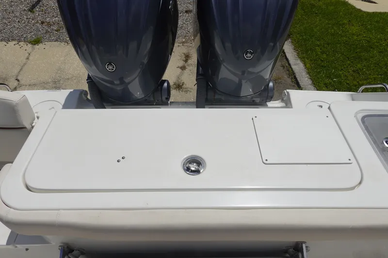 Slide: The Image of 2022 Sea Hunt Gamefish 27 Coffin Box with dual outboard motors, rear deck view. - 7