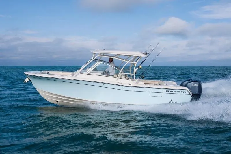 The Image of 2027 Grady-White Freedom 285 boat cruising on open water under a clear sky. - 0