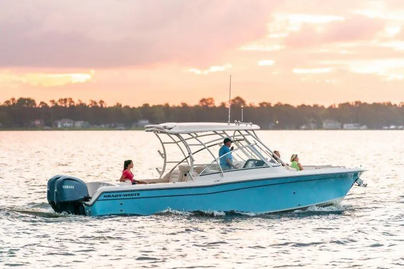 Slide: The Image of 2027 Grady-White Freedom 285 boat cruising at sunset on calm waters. - 2