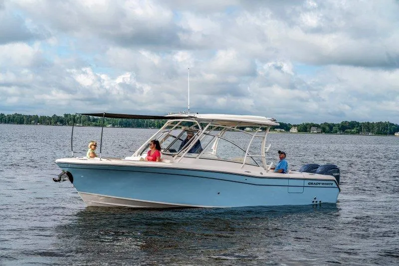 Slide: The Image of 2027 Grady-White Freedom 285 boat cruising on a lake under cloudy skies. - 3