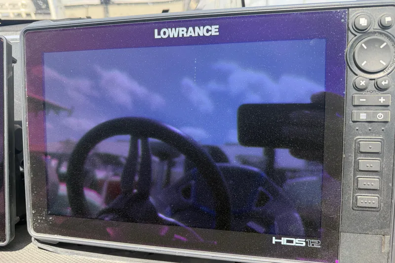 Slide: The Image of Lowrance HDS12 display on 2022 Ranger Z520R Cup-Equipped boat, reflecting steering wheel and sky. - 10