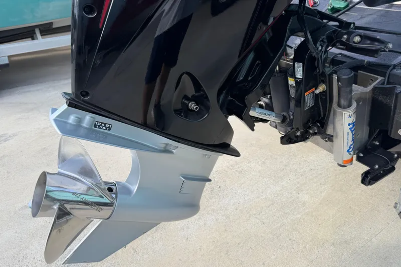 Slide: The Image of 2022 Ranger Z520R Cup-Equipped boat motor and propeller detail on concrete surface. - 112