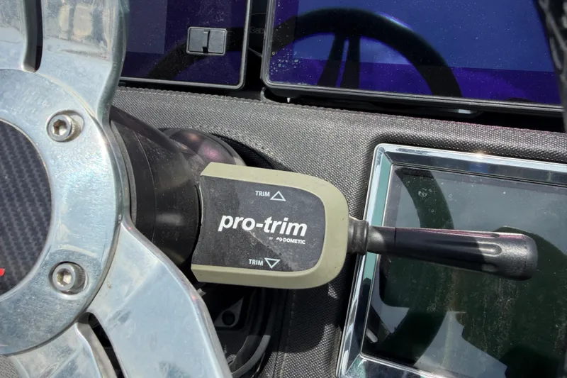 Slide: The Image of Close-up of 2022 Ranger Z520R Cup-Equipped boat's steering wheel and pro-trim control. - 12