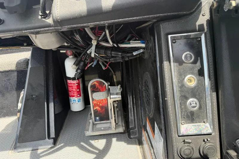Slide: The Image of Interior of 2022 Ranger Z520R Cup-Equipped boat showing wiring, fire extinguisher, and control panel. - 13