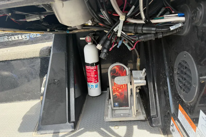 Slide: The Image of 2022 Ranger Z520R Cup-Equipped boat interior with wiring, fire extinguisher, and foot pedal. - 14