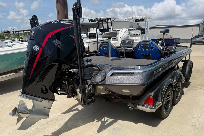 Slide: The Image of 2022 Ranger Z520R Cup-Equipped boat with powerful outboard motor, parked outdoors. - 2