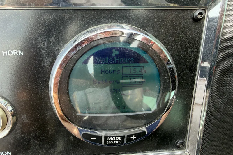 Slide: The Image of Close-up of a 2022 Ranger Z520R Cup-Equipped dashboard display showing hours and battery status. - 26