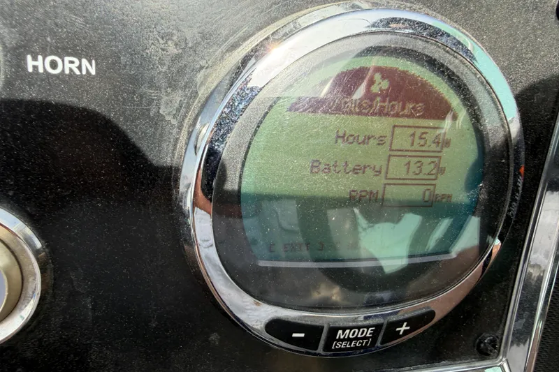 Slide: The Image of Close-up of a 2022 Ranger Z520R Cup-Equipped dashboard display showing hours and battery level. - 27