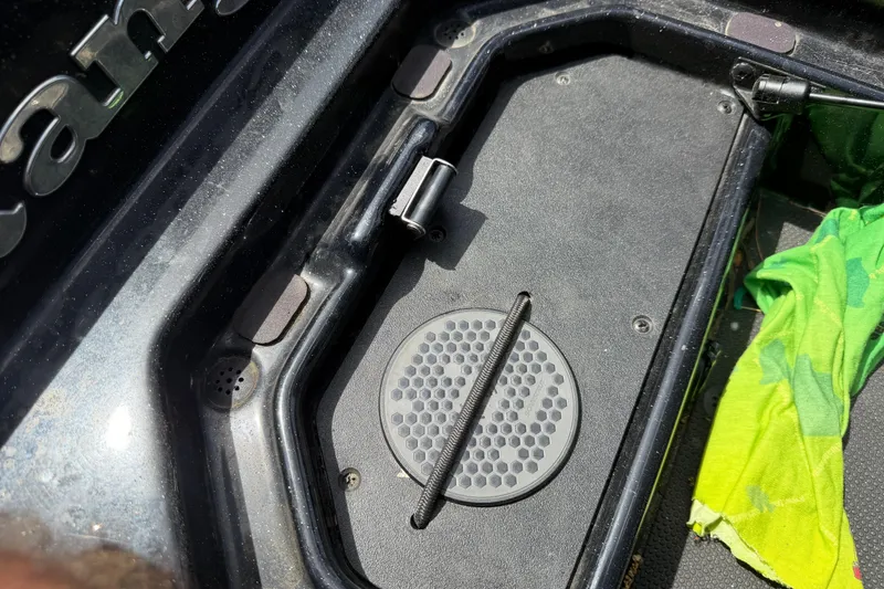 Slide: The Image of 2022 Ranger Z520R Cup-Equipped boat compartment with secure latch and vibrant green cloth. - 37