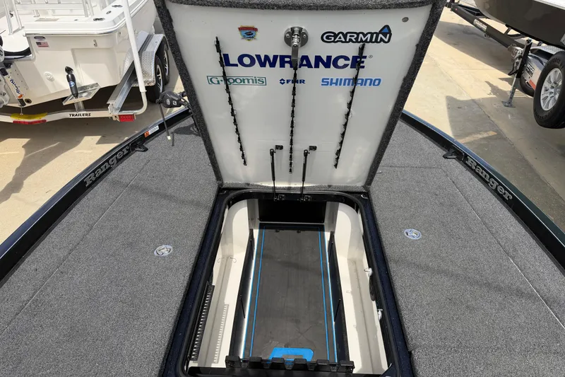 Slide: The Image of 2022 Ranger Z520R Cup-Equipped boat with open storage compartment, featuring Garmin and Lowrance logos. - 43