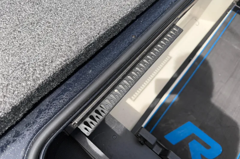 Slide: The Image of 2022 Ranger Z520R Cup-Equipped boat interior detail with textured surface and storage compartment. - 46