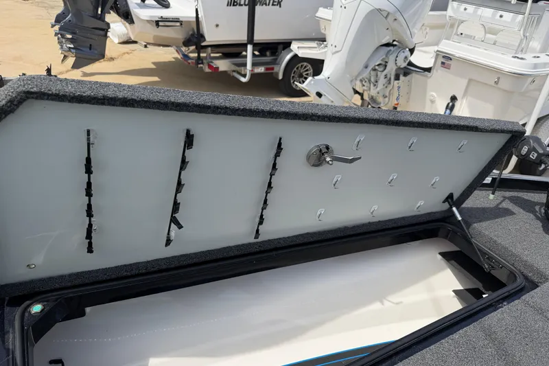 Slide: The Image of Open storage compartment of 2022 Ranger Z520R Cup-Equipped boat, showing interior hooks and latch. - 51