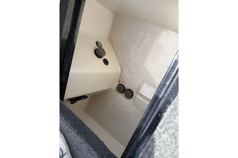 Slide: The Image of Interior compartment of 2022 Ranger Z520R Cup-Equipped boat, showing storage space and drainage features. - 65