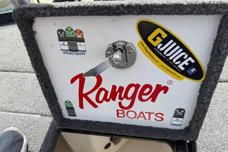 Slide: The Image of 2022 Ranger Z520R Cup-Equipped boat compartment with stickers and latch detail. - 66