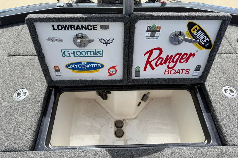 Slide: The Image of 2022 Ranger Z520R Cup-Equipped boat storage compartment with various brand stickers. - 67