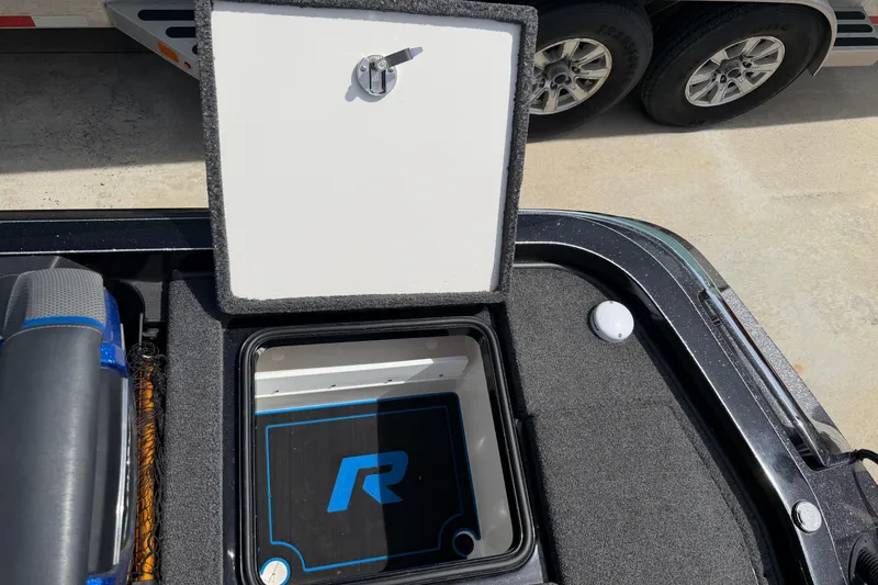 Slide: The Image of 2022 Ranger Z520R Cup-Equipped boat storage compartment with open lid, showcasing interior design. - 69