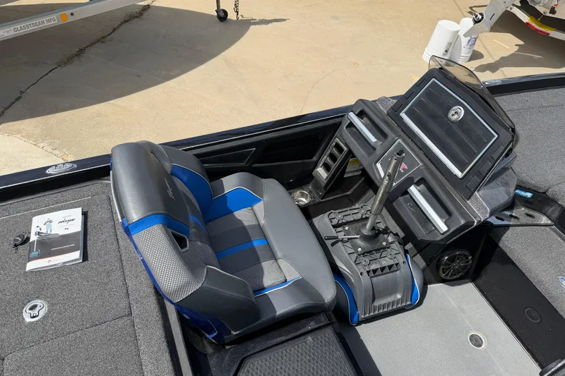 Slide: The Image of 2022 Ranger Z520R Cup-Equipped boat interior with blue and gray seating and control panel. - 73
