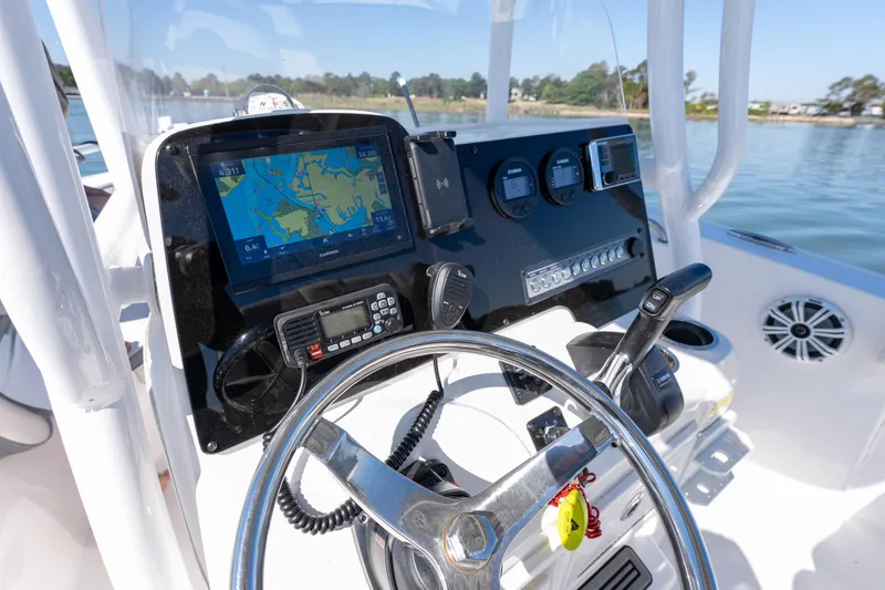 Slide: The Image of 2021 Tidewater 220 LXF boat dashboard with navigation system and controls. - 10