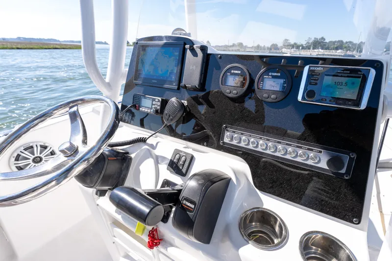 Slide: The Image of Center console of a 2021 Tidewater 220 LXF boat with navigation and control instruments. - 11