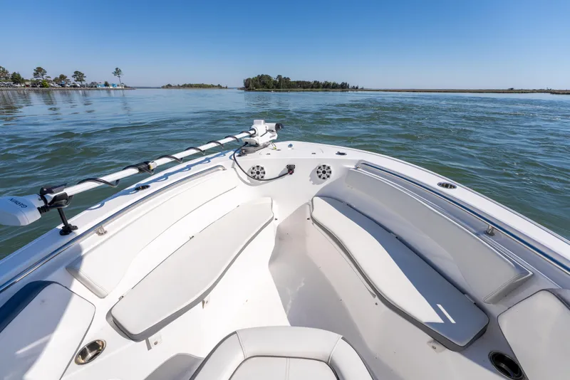 Slide: The Image of 2021 Tidewater 220 LXF boat on calm water with clear blue sky. - 13
