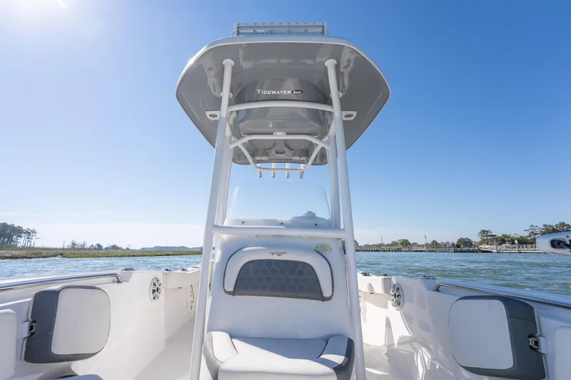 Slide: The Image of 2021 Tidewater 220 LXF boat on water, featuring sleek design and spacious seating. - 14