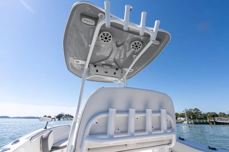 Slide: The Image of 2021 Tidewater 220 LXF boat with T-top and rod holders on a sunny day. - 16