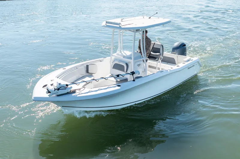 Slide: The Image of 2021 Tidewater 220 LXF boat cruising on calm water, featuring a sleek design and modern amenities. - 2