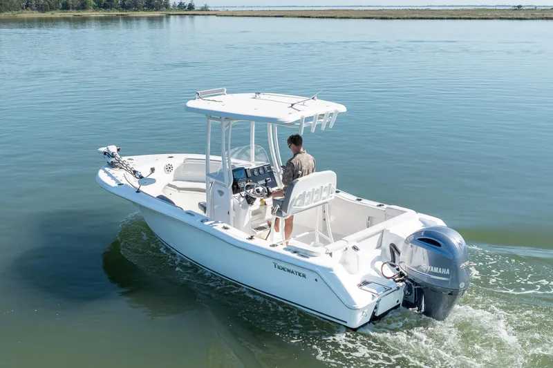 Slide: The Image of 2021 Tidewater 220 LXF boat cruising on calm water with Yamaha engine. - 4
