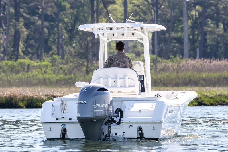 Slide: The Image of 2021 Tidewater 220 LXF boat with Yamaha engine cruising on a scenic waterway. - 9