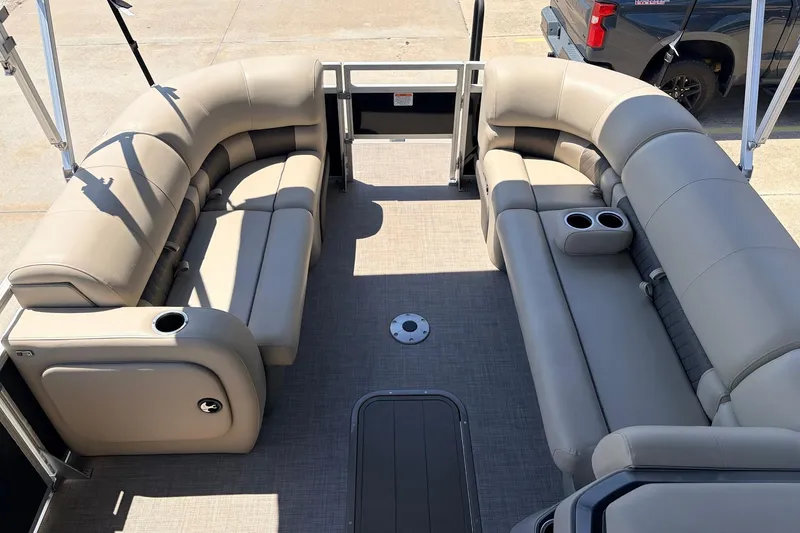 Slide: The Image of 2024 Sun Tracker SportFish 22 XP3 pontoon boat interior with beige seating and cup holders. - 10