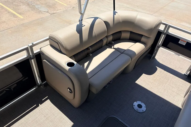 Slide: The Image of 2024 Sun Tracker SportFish 22 XP3 pontoon boat interior with beige seating and cup holder. - 11