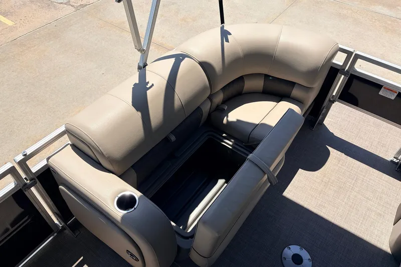 Slide: The Image of 2024 Sun Tracker SportFish 22 XP3 pontoon boat with beige seating and storage compartment. - 13