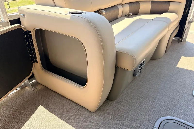 Slide: The Image of 2024 Sun Tracker SportFish 22 XP3 boat interior with open storage compartment and cushioned seating. - 15