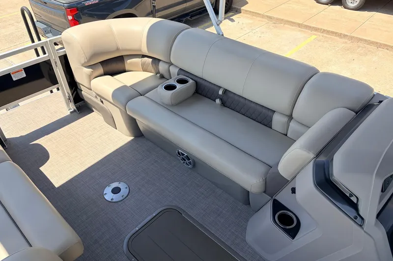 Slide: The Image of 2024 Sun Tracker SportFish 22 XP3 pontoon boat interior with beige seating and cup holders. - 16