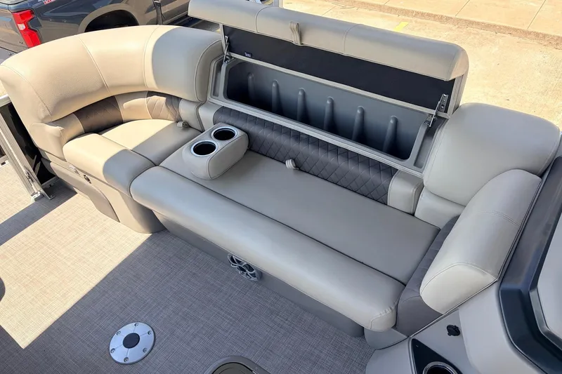 Slide: The Image of 2024 Sun Tracker SportFish 22 XP3 boat interior with cushioned seating and storage. - 17