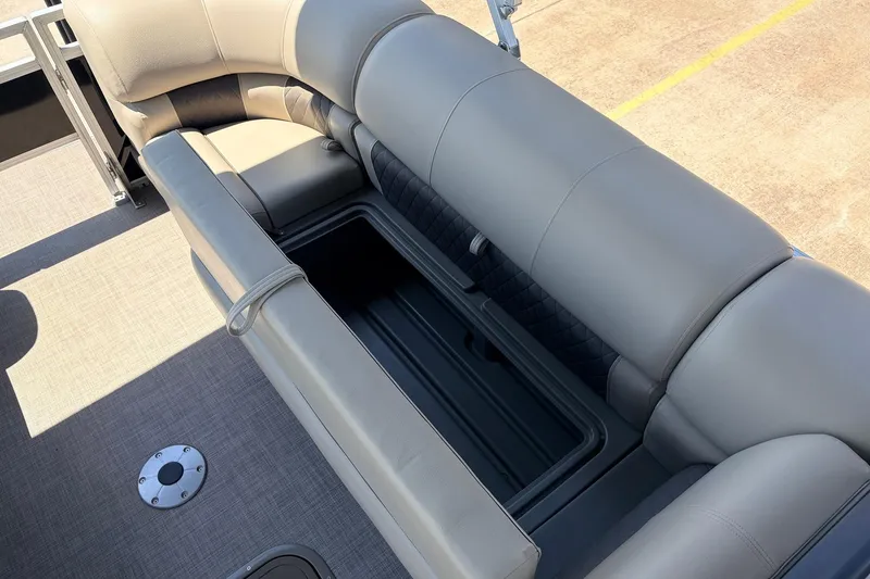 Slide: The Image of 2024 Sun Tracker SportFish 22 XP3 boat interior with cushioned seating and storage compartment. - 19