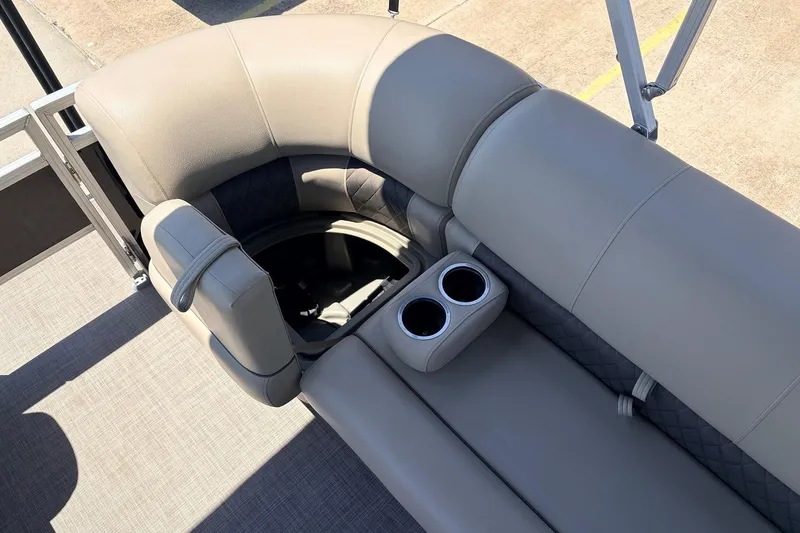 Slide: The Image of 2024 Sun Tracker SportFish 22 XP3 boat interior with plush seating and cup holders. - 20