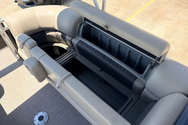 Slide: The Image of 2024 Sun Tracker SportFish 22 XP3 boat seating with open storage compartment. - 21