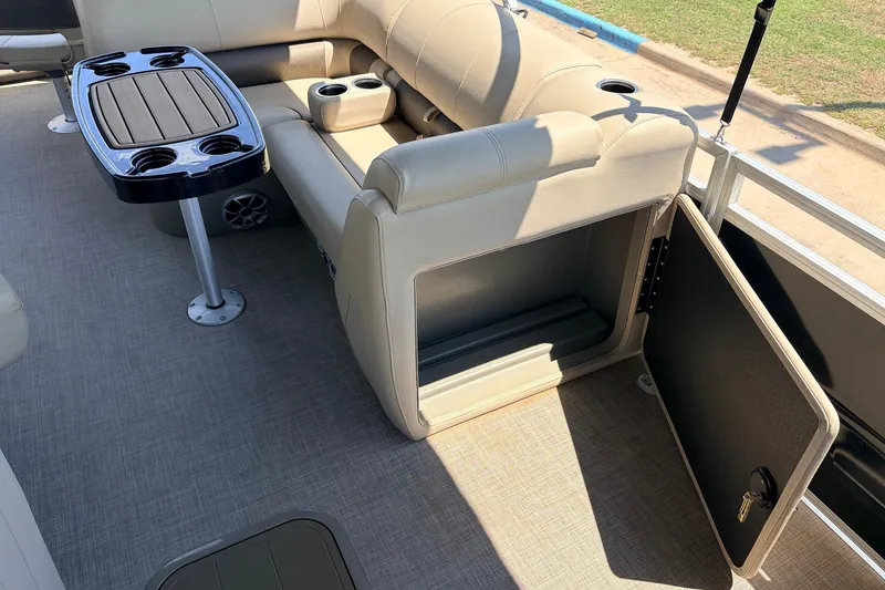Slide: The Image of 2024 Sun Tracker SportFish 22 XP3 interior with seating, storage, and cupholders. - 25