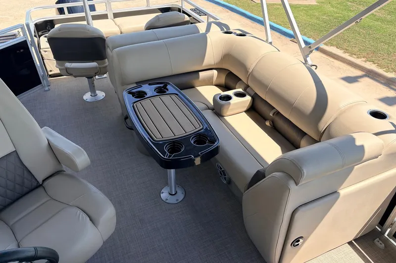 Slide: The Image of 2024 Sun Tracker SportFish 22 XP3 interior with beige seating and table. - 26