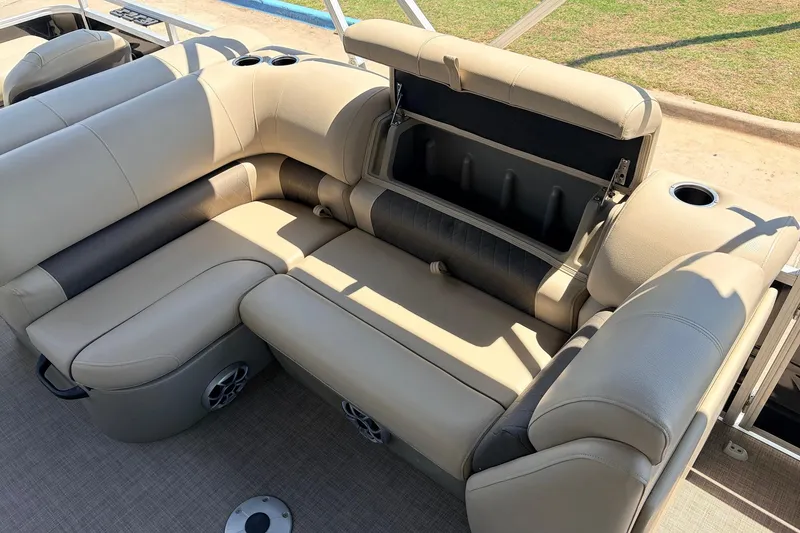 Slide: The Image of 2024 Sun Tracker SportFish 22 XP3 pontoon boat with beige seating and storage compartment. - 28
