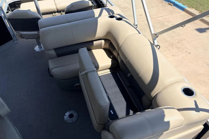 Slide: The Image of 2024 Sun Tracker SportFish 22 XP3 boat interior with beige seating and cup holders. - 29